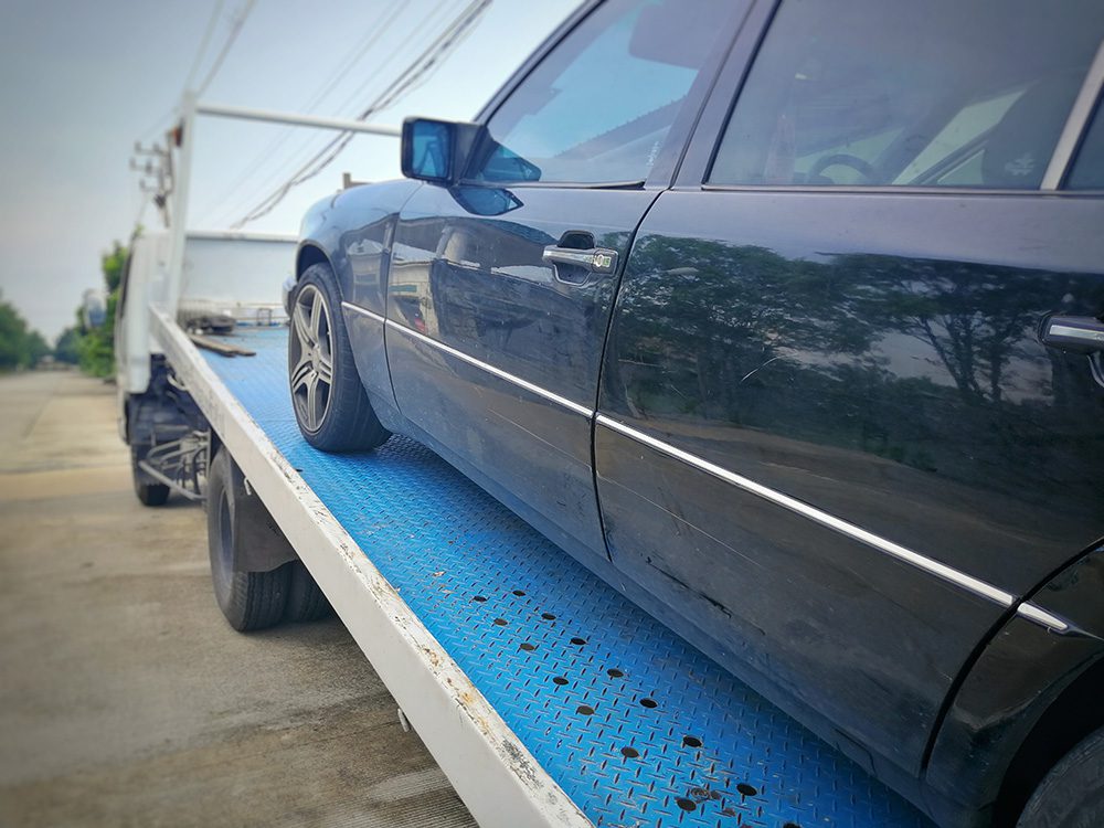 scrap car on back of pick-up truck